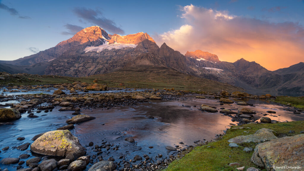 Mount Harmukh glowing in sunset light above rocky stream near Gangbal Lake on Kashmir Great Lakes Trek